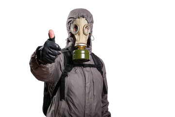 An isolated shot of a man dressed in a gas mask, a hooded jacket, a backpack, raised his thumb up, gesture ok, looking into the camera. On a white isolated background