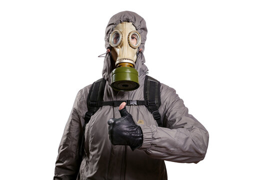 An isolated shot of a man dressed in a gas mask, a hooded jacket, a backpack, raised his thumb up, gesture ok, looking into the camera. On a white isolated background