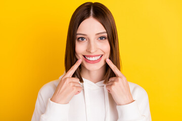 Photo of candid lady direct fingers healthy teeth implants wear white hoodie isolated yellow color background