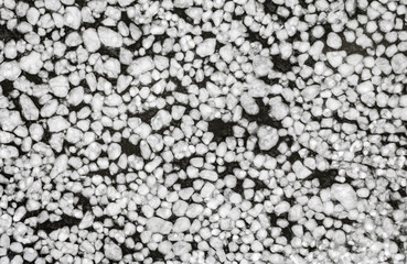 abstract texture of broken white ice and dark blue water. View of the ice from a drone. background of the frozen surface of a clean lake or river