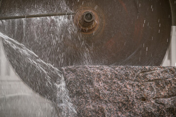 Big industrial machine cutting stone in a factory
