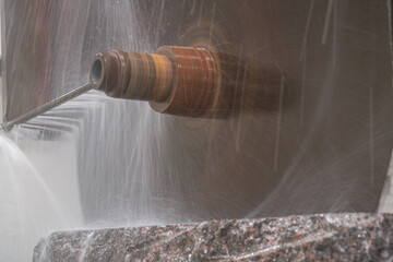 Big industrial machine cutting stone in a factory