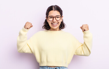 pretty teenager woman feeling happy, positive and successful, celebrating victory, achievements or...