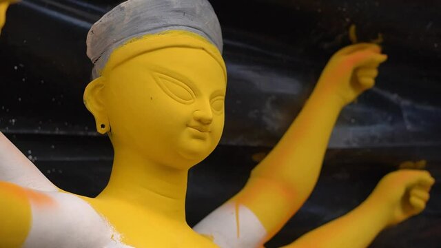 KOLKATA, INDIA - Oct 10, 2021: Half painted idol of Goddess Durga captured from left side Idols being prepared for the upcoming festivities during Durga