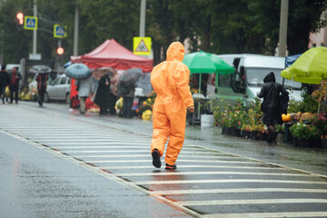 a man in a biosecurity suit on the street