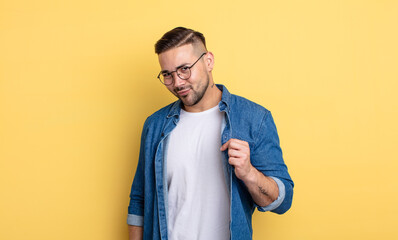 young handsome man looking arrogant, successful, positive and proud, pointing to self