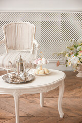 lunch time. vintage plate with marshmallows on a white table near the window in a classic interior near white wall background. free space