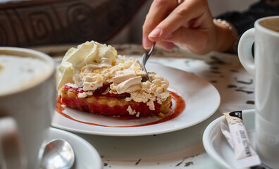 A beautiful female hand takes dessert