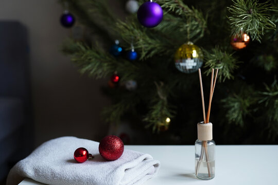 Christmas Or New Year Home Fragrance With Air Freshener Sticks In Front Of Festive Tree. Winter Holiday Aromatherapy