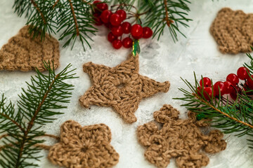 Cute Christmas toys with spruce twigs on a light background. Christmas eco friendly toys.