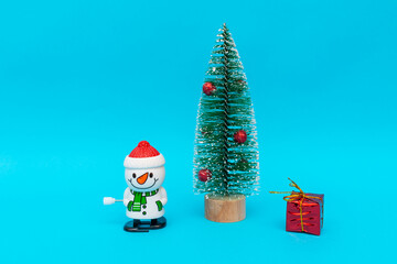 Toy snowman, presents and Christmas tree with copy space.new year celebration.