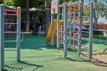Fototapeta na wymiar colorful childrens playground in a modern public green park 