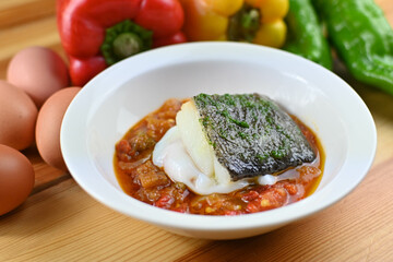Delicious dish of fresh hake with fresh peppers and vegetables. Typical hemp plate of the cantabrian. Gourmet dish of fresh fish and vegetables.