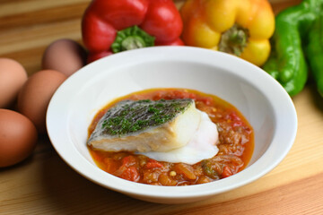 Delicious dish of fresh hake with fresh peppers and vegetables. Typical hemp plate of the cantabrian. Gourmet dish of fresh fish and vegetables.