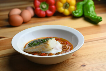 Delicious dish of fresh hake with fresh peppers and vegetables. Typical hemp plate of the cantabrian. Gourmet dish of fresh fish and vegetables.