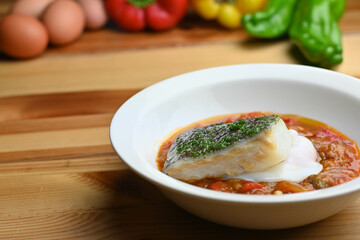 Delicious dish of fresh hake with fresh peppers and vegetables. Typical hemp plate of the cantabrian. Gourmet dish of fresh fish and vegetables.
