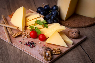 Kashar cheese or kashkaval cheese on wood floor. Cheese slices on the serving board (Turkish name; Kars Kasari)