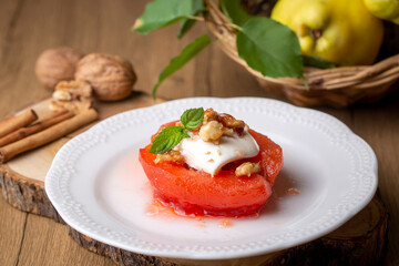 Traditional Turkish style quince dessert. The quince is cooked until soft, sherbet is poured on it, and served with cream and walnuts. It is one of the most popular Turkish desserts.(Ayva Tatlisi)