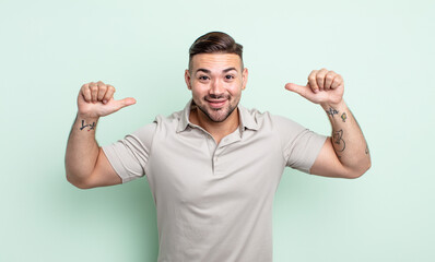 young handsome man feeling proud, arrogant and confident, looking satisfied and successful,...
