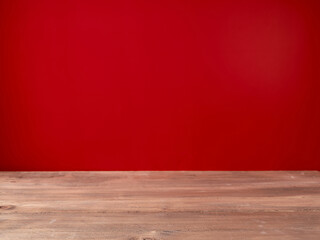 Wooden table on red wall background