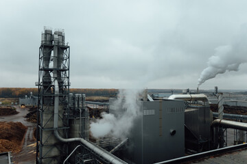view of the factory pipes and workshops. working industrial production. harmful emissions of gases from pipes. metallurgical plant. communications and production lines