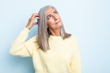 middle age gray hair woman feeling puzzled and confused, scratching head and looking to the side