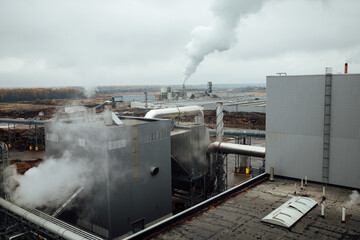 view of the factory pipes and workshops. working industrial production. harmful emissions of gases from pipes. metallurgical plant. communications and production lines