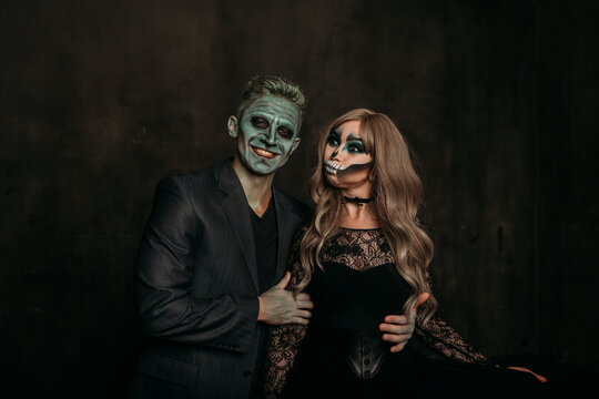 The image of a skeleton girl and the image of a Frankenstein man on Halloween in the dark. an image for a couple on Halloween