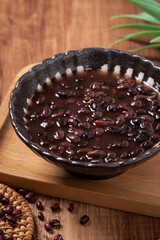Adzuki red bean soup on wooden table background.