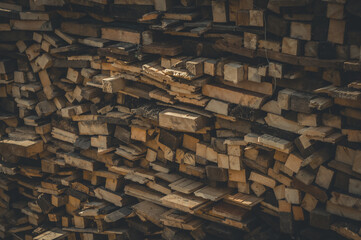 Sawn wood stacked in stacks. Harvesting firewood for winter. Wood fuel for the stove. Selective focus.