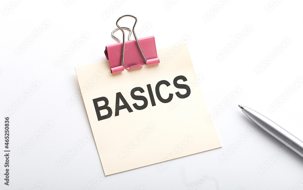 Poster basics text on the sticker with pen on the white background