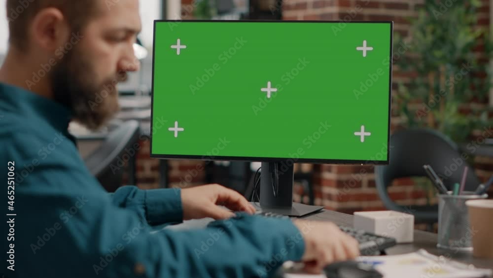 Poster close up of man working on horizontal green screen at desk to design business project and presentati