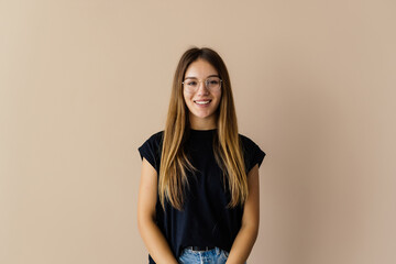 Portrait of cheerful brunette woman isolated on beige background