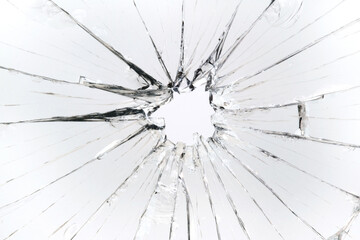 The hole in the broken and cracked glass, closeup