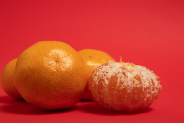 Mandarin oranges on a red background