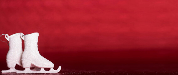 white ice skates on red isolated background christmas new year concept