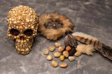 Stone runes and pouch on concrete gray background. The concept of horoscopes and fortune-telling. Magic stones. Astrology and esoterism. Stones with the sign of the zodiac. Top table view and close-up