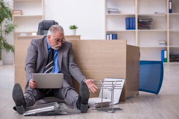 Old male employee unhappy with excessive work in the office