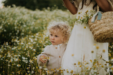 Baby boy with mother at flower field