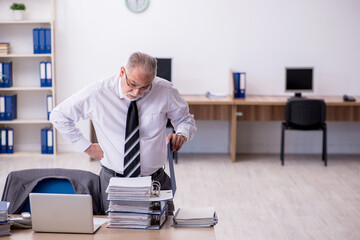 Old male employee unhappy with excessive work in the office