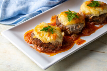 Turkish Food Hasanpasa Kofte - Kofta with Puree - Meatball with Bechamel Sauce and Green Peas. Traditional Food.