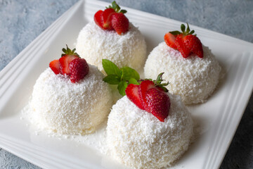 Delicious milk dessert; cup dessert with coconut and strawberry (Turkish name; fincan tatlisi