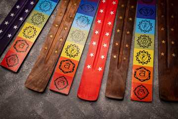 Aromatherapy and meditation. Stick stand on gray background. Close up view wooden stands on grey...