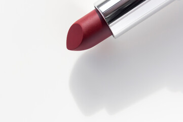 Red lipstick on white background. Beauty and cosmetics background. Decorative cosmetics, makeup,...