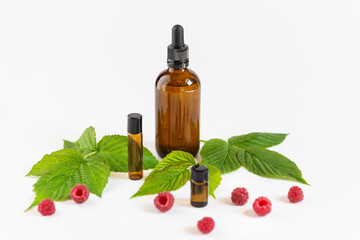 Raspberry oil for face and body skin care in glass bottles.