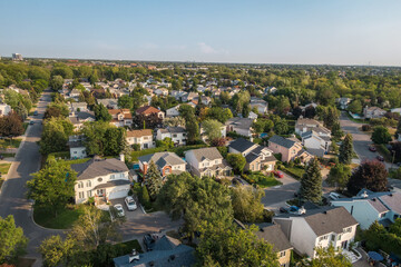 Naklejka premium Aerial view of houses and streets in beautiful residential neighbourhood in Montreal, Quebec, Canada. Property, housing and real estate concept, summer season.