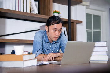 asian guy try to finished his messy work till late night