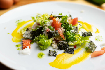 Delicious rice salad with lettuce, tomato, escarole and seaweed. Gourmet salad with natural products.