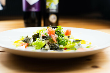 Delicious rice salad with lettuce, tomato, escarole and seaweed. Gourmet salad with natural products.