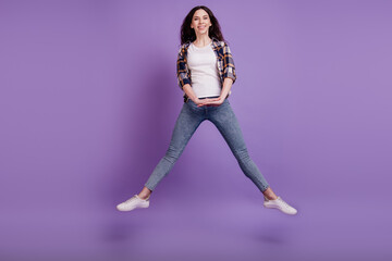 Full size photo of young attractive girl happy positive smile jump up have fun isolated over violet...